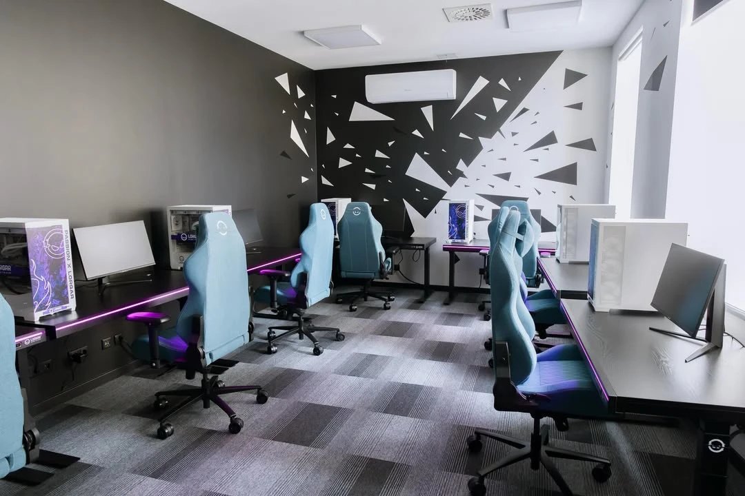 Inside the A&P Performance Lab in Riga: a row of stations with LORGAR computers, chairs and LED desk lighting